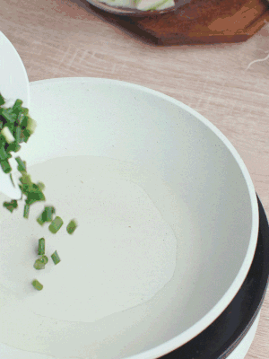 熱油下臘肉、蔥花煸炒，再下西葫蘆。